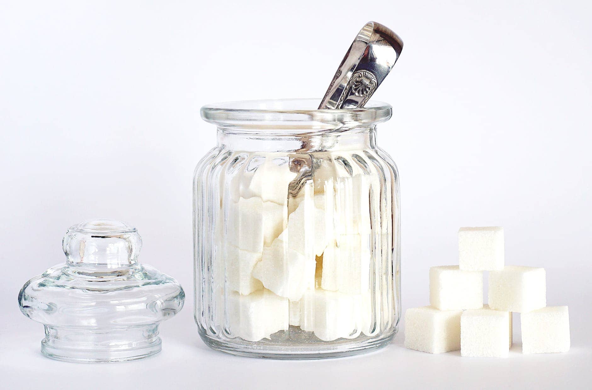 close up photo of sugar cubes in glass jar