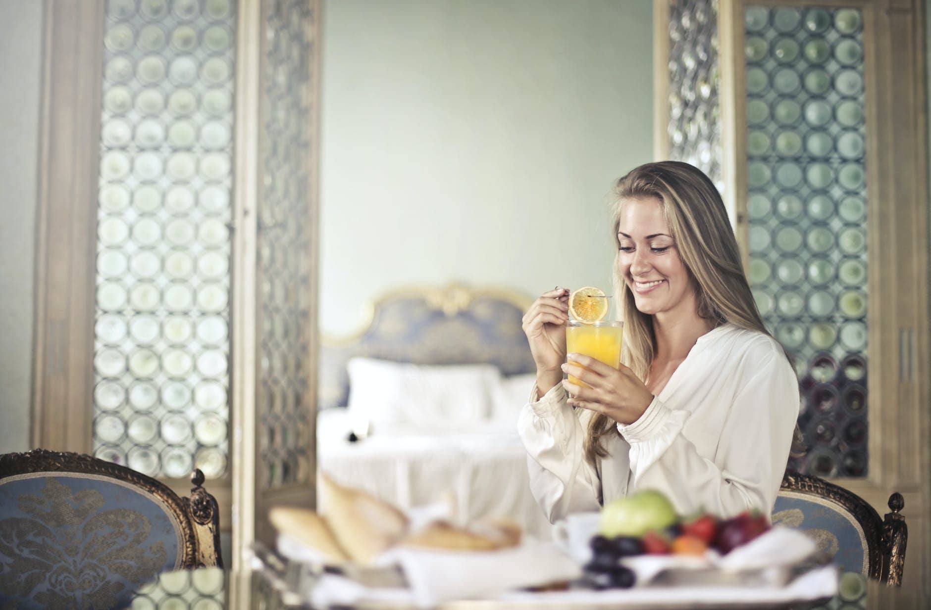 cheerful woman enjoying breakfast in morning