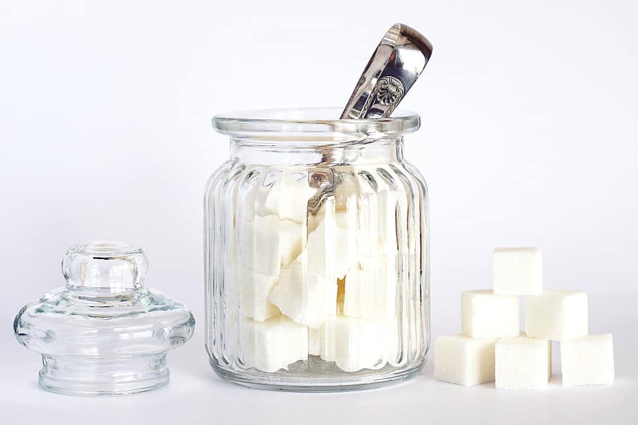 close up photo of sugar cubes in glass jar