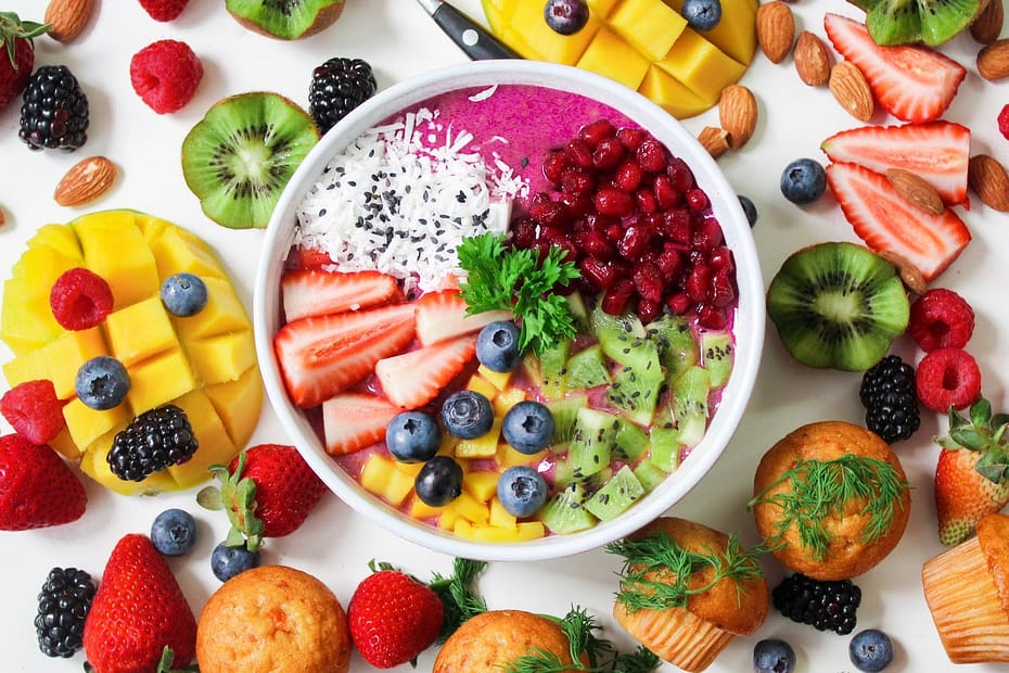 assorted sliced fruits in white ceramic bowl